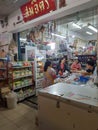 A woman buying some consumer goods in old grocer`s street shop.